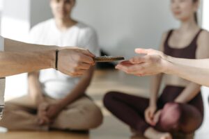 Group meditation practice with calming hand gesture