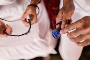 Hands holding prayer beads in contemplative practice